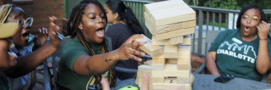 Students reacting to playing a game of Jenga