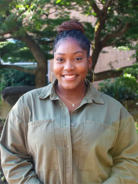 Briana Wilson in a green button up smiling outside