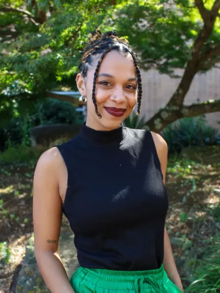 Shayauna Newsom smiling in a black shirt outside