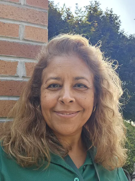 Amparo Ramos taking a selfie outside in Charlotte green