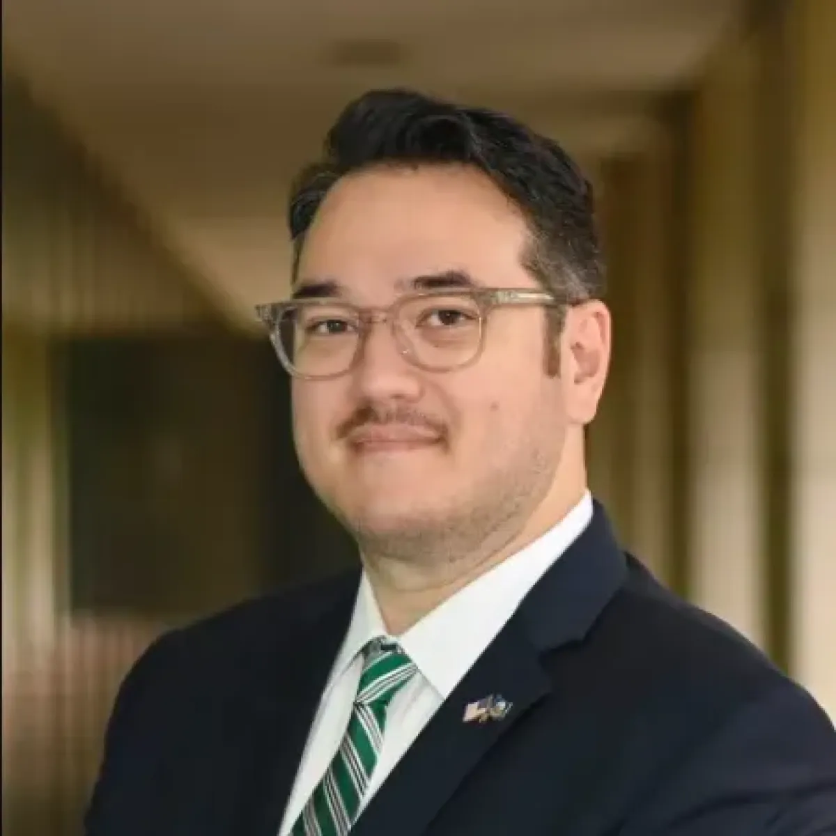 Chris Brasel smiling in a suit and tie