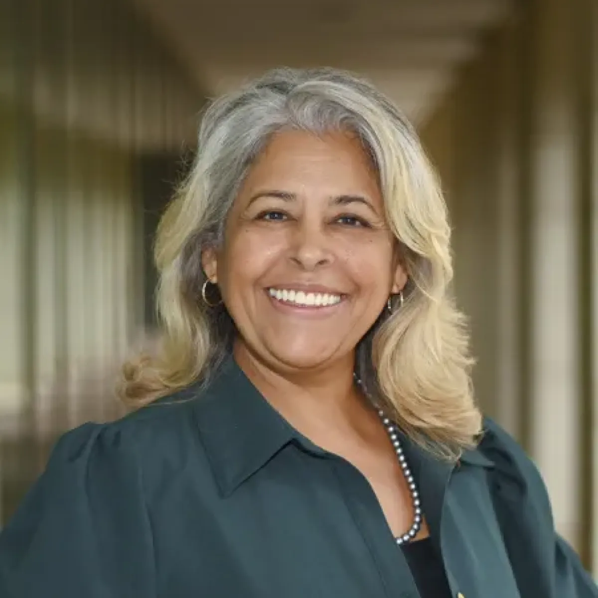 Amparo Ramos smiling in a hallway